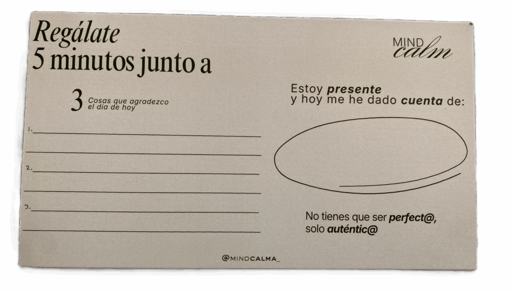 Una tarjeta de ejercicios de bienestar de "Mindcalm" con un diseño minimalista. El texto invita a tomarse 5 minutos e incluye secciones para escribir: tres cosas para agradecer hoy, un espacio circular para anotar de qué se ha dado cuenta la persona al estar presente, y el mensaje motivador: "No tienes que ser perfect@, solo auténtic@